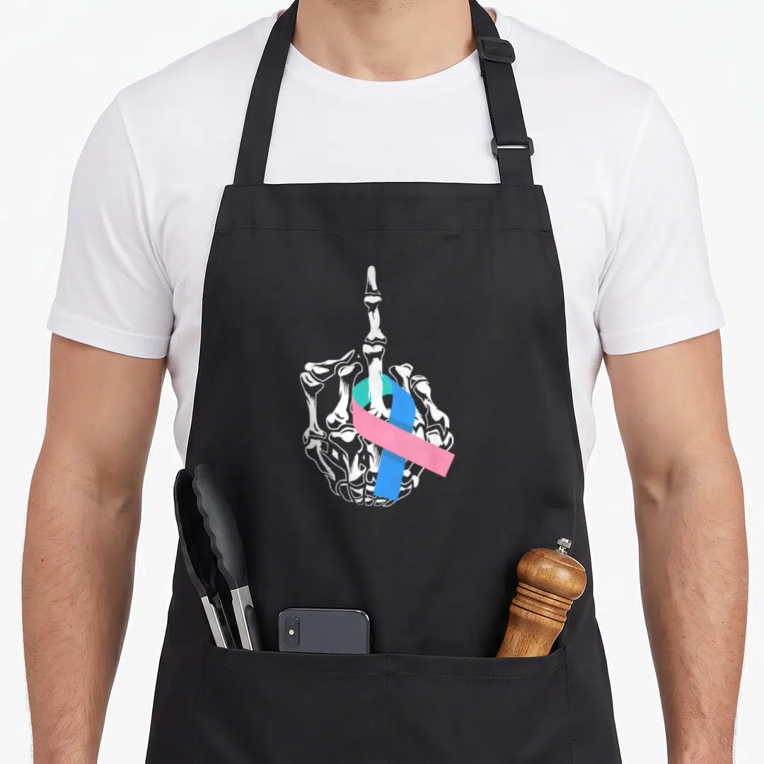 Middle thyroid apron - White skeleton hand middle finger with blue pink teal awareness ribbon — shown on a black cotton canvas apron against a white background