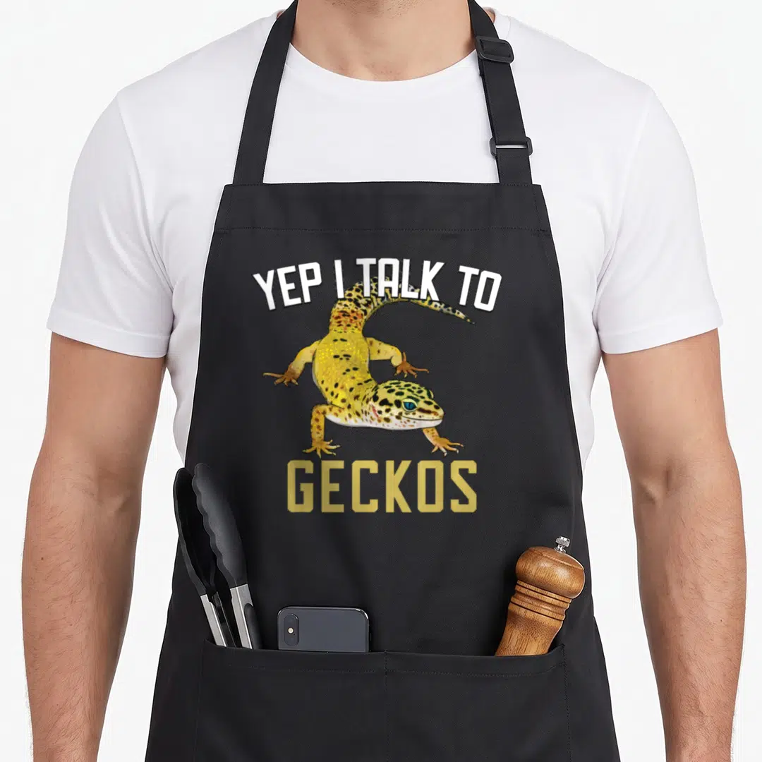 Yep leopard apron - Realistic yellow spotted gecko with YEP I TALK TO GECKOS text — shown on a black cotton canvas apron against a white background
