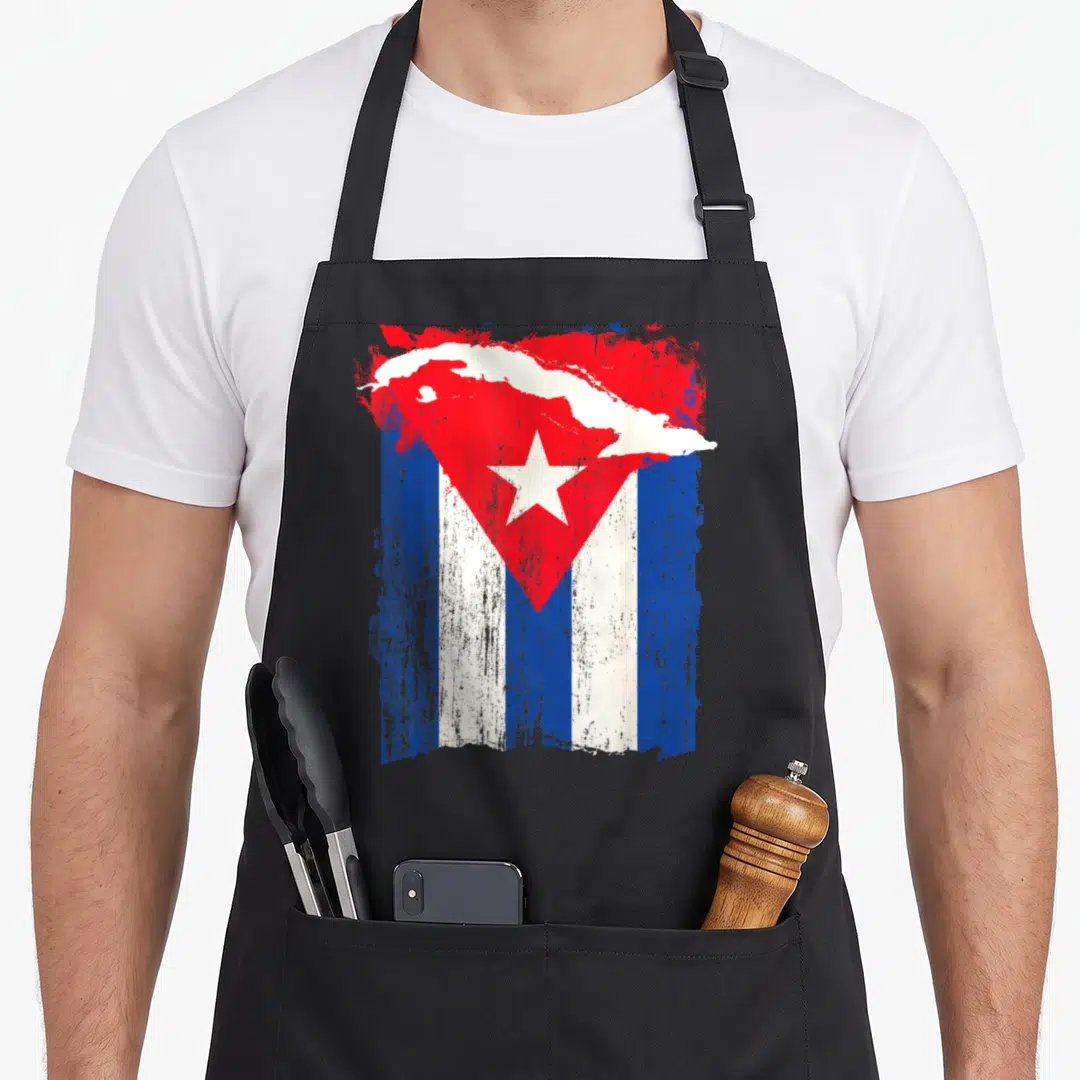 Flag cuban apron - Distressed Cuban flag with white map silhouette overlay on black bib — shown on a black cotton canvas apron against a white background