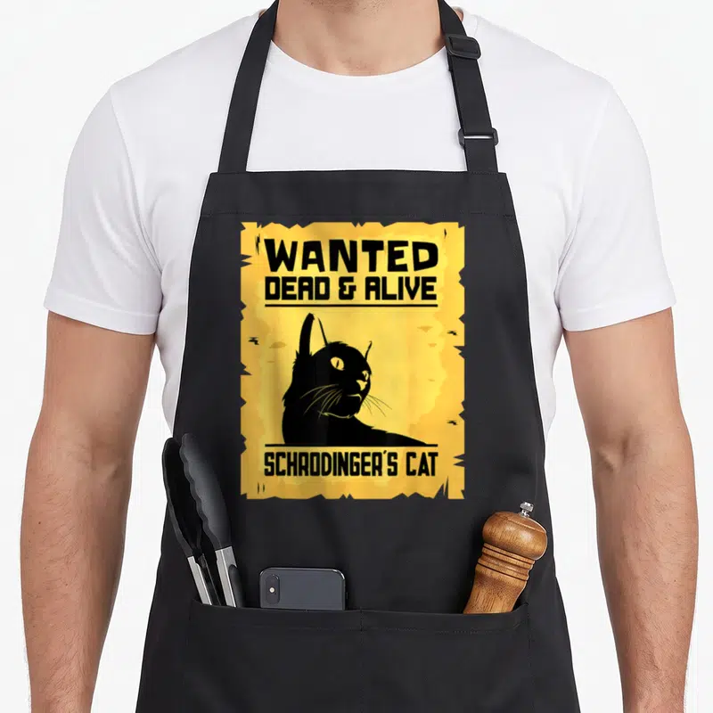 Physicist cat apron - Yellow wanted poster with black cat silhouette and text WANTED DEAD & ALIVE SCHRODINGER'S CAT — shown on a black cotton canvas apron against a white background