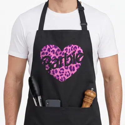 Funny leopard apron - Pink leopard heart with grey Barbie text overlay — shown on a black cotton canvas apron against a white background