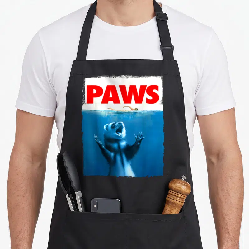 Paw i love my rat apron - Red PAWS text above ferret underwater reaching for swimmer photo — shown on a black cotton canvas apron against a white background