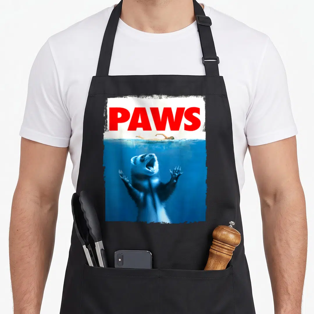 Paw i love my rat apron - Red PAWS text above ferret underwater reaching for swimmer photo — shown on a black cotton canvas apron against a white background