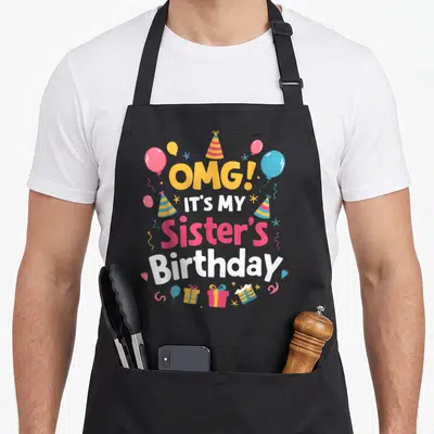 Squad omg birthday apron - Stacked text OMG Sister Birthday with cartoon balloons, striped hats, and gifts in yellow — shown on a black cotton canvas apron against a white background