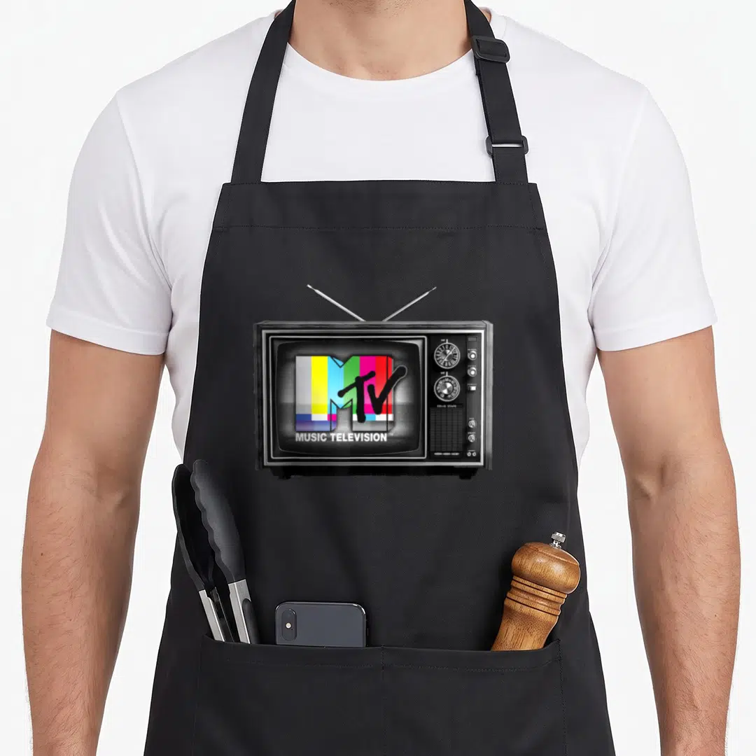 Original tv apron - Vintage TV set with two antennas displaying MTV logo and MUSIC TELEVISION text on screen — shown on a black cotton canvas apron against a white background