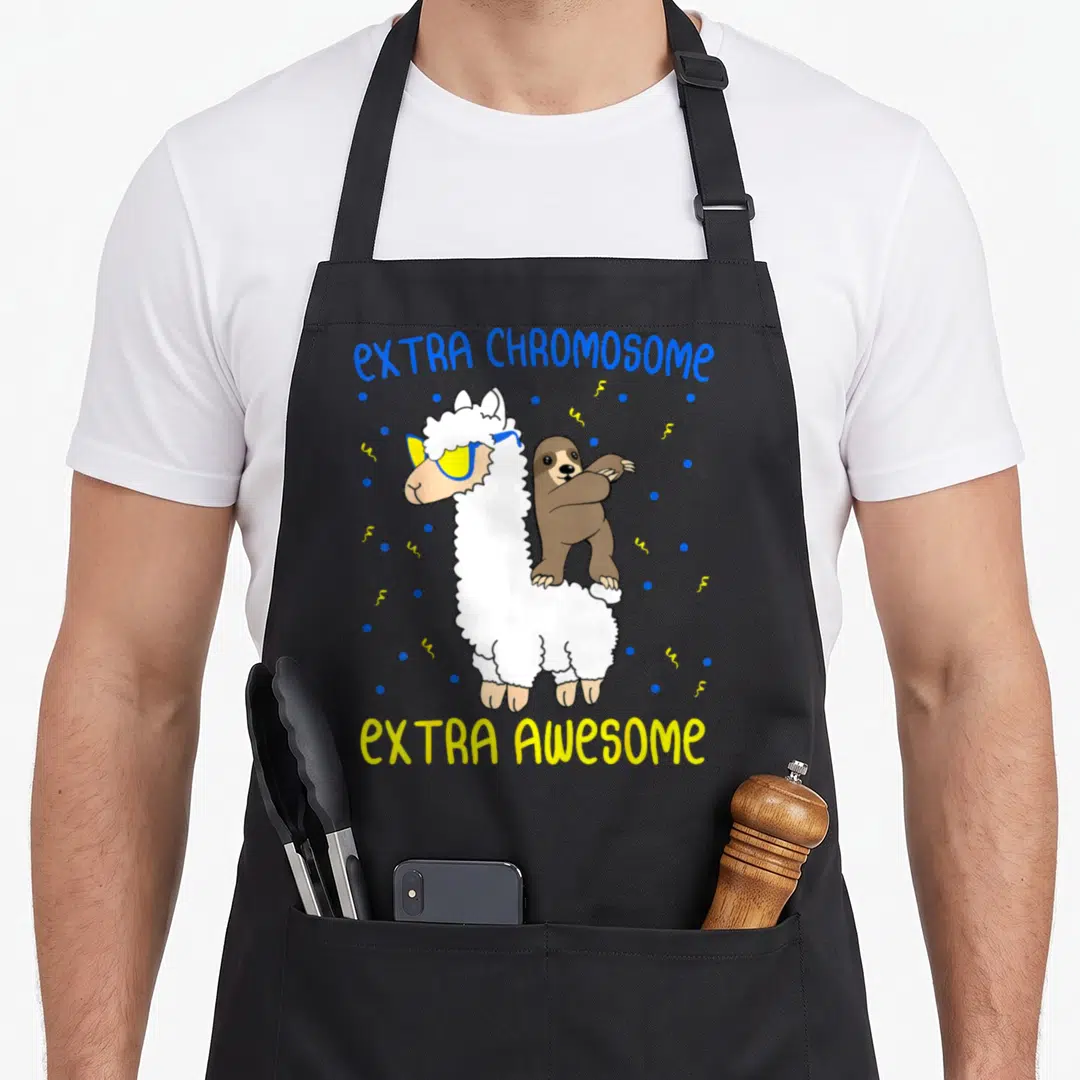 Syndrome awareness an extra apron - Cartoon llama with sunglasses and dabbing sloth, EXTRA CHROMOSOME EXTRA AWESOME — shown on a black cotton canvas apron against a white background