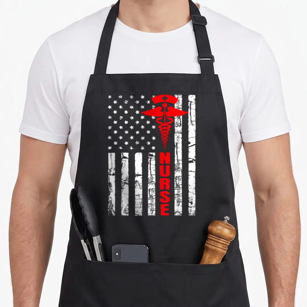 Patriotic nursing apron - Distressed flag background with red caduceus and vertical NURSE text — shown on a black cotton canvas apron against a white background
