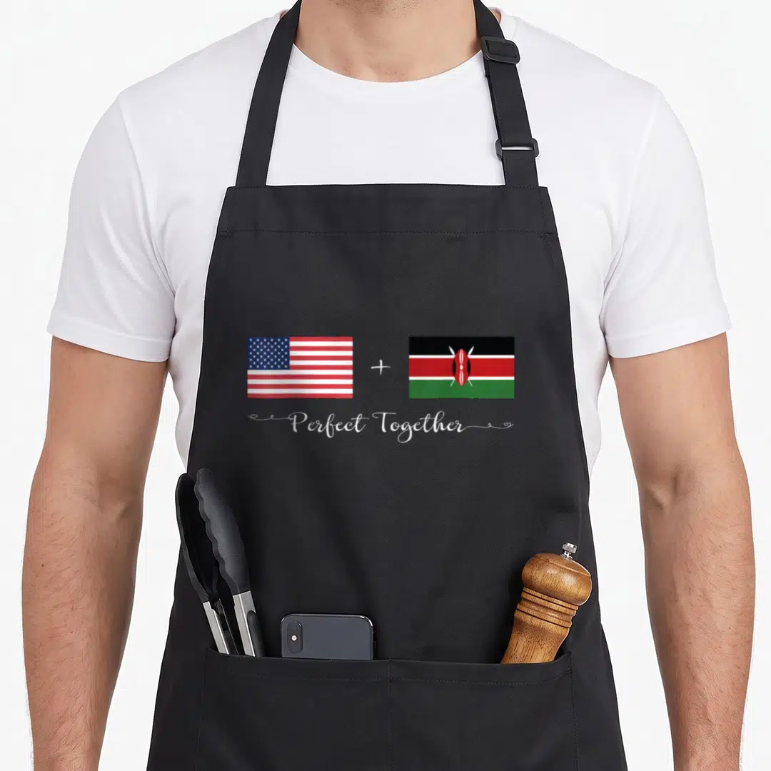 Perfect american flag apron - US and Kenya flags side by side with plus sign and Perfect Together script — shown on a black cotton canvas apron against a white background