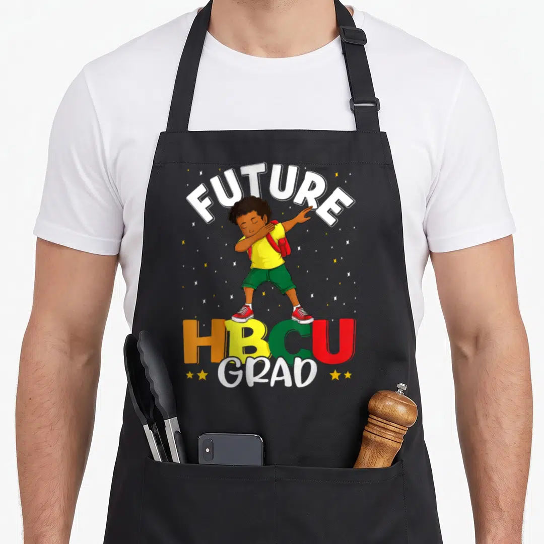 Grad college apron - Cartoon boy dabbing under FUTURE text above HBCU GRAD in yellow green red — shown on a black cotton canvas apron against a white background