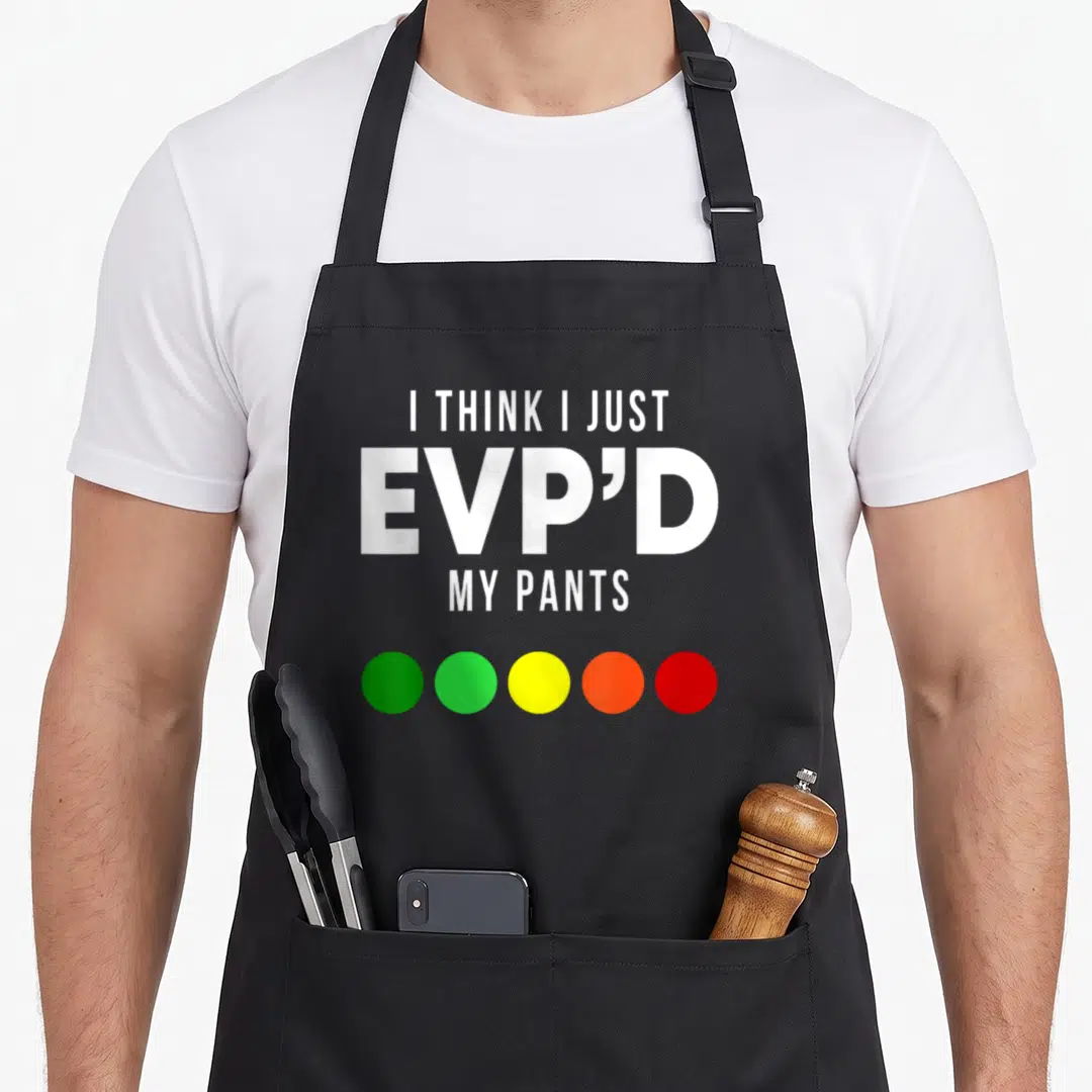 Evpd hunter apron - White text I THINK I JUST EVP'D MY PANTS above five green yellow orange and red circles — shown on a black cotton canvas apron against a white background
