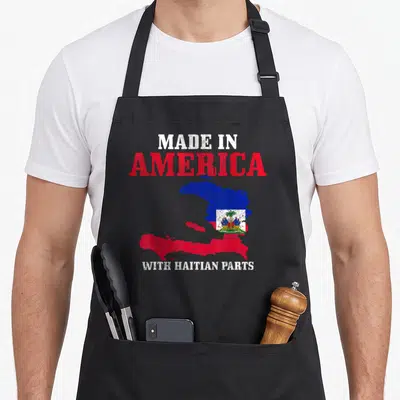 Haitian american flag apron - Distressed map of Haiti in red and blue with Made in America text — shown on a black cotton canvas apron against a white background