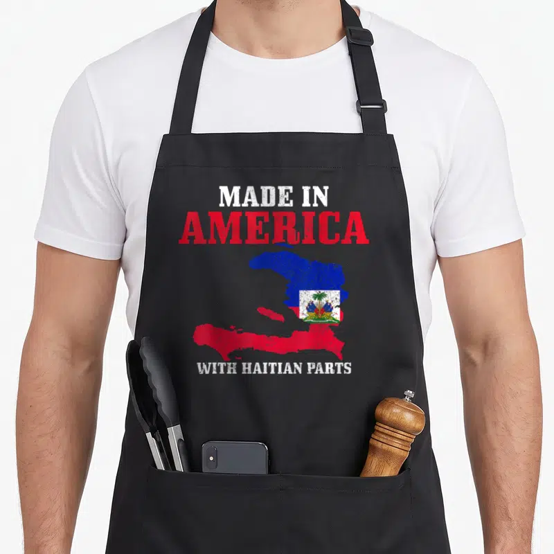 Haitian american flag apron - Distressed map of Haiti in red and blue with Made in America text — shown on a black cotton canvas apron against a white background