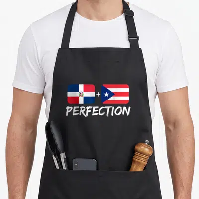 Puerto dominican pride apron - Two flags separated by a plus sign above the word PERFECTION in white brush lettering — shown on a black cotton canvas apron against a white background