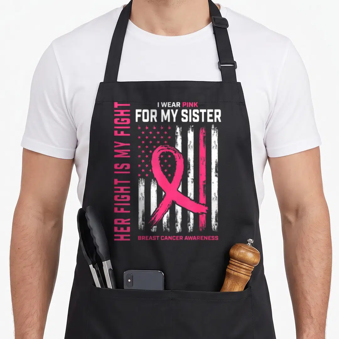 Fight cancer girl apron - Pink ribbon over distressed flag with I wear pink for my sister text — shown on a black cotton canvas apron against a white background