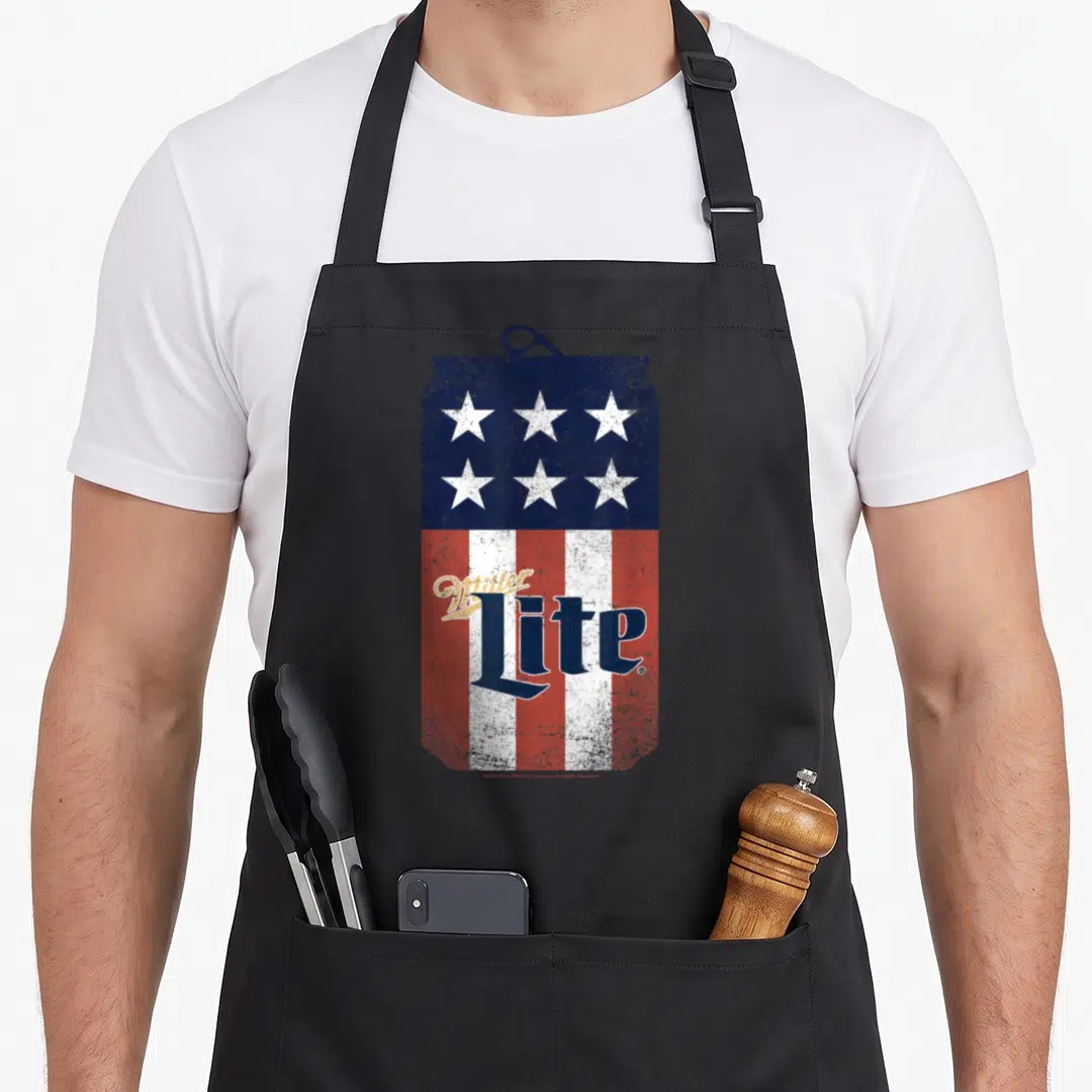 Coor 4th of july apron - Distressed beer can with US flag pattern and Miller Lite text in blue red white — shown on a black cotton canvas apron against a white background