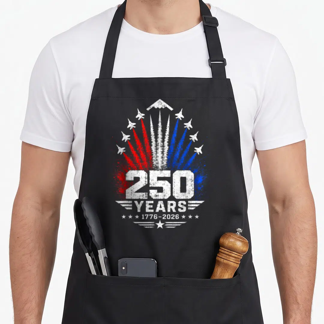 Jet patriotic apron - 250 YEARS 1776-2026 jet planes red white blue distressed smoke trails — shown on a black cotton canvas apron against a white background