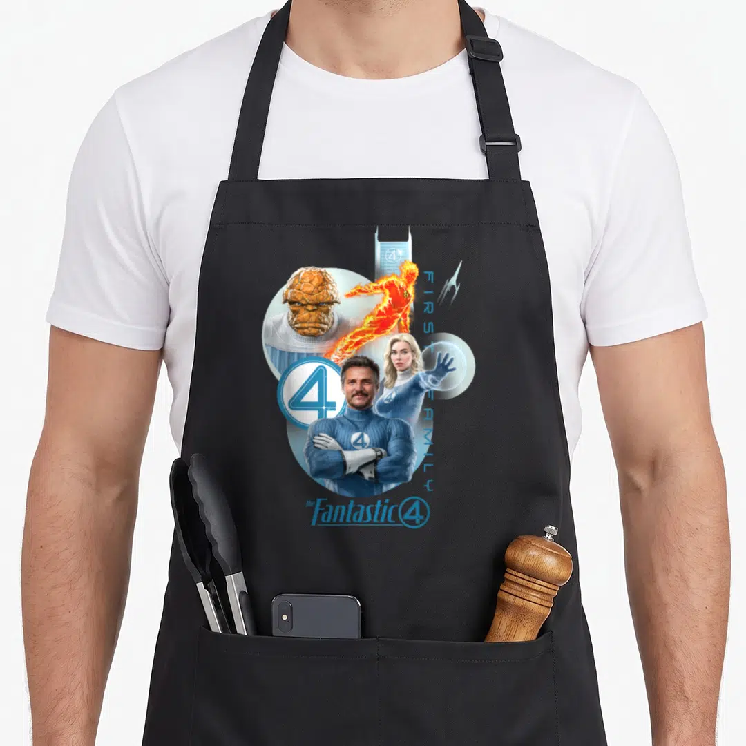 Fantastic family aprons - Photo-style Fantastic Four cluster with blue orange white suits, vertical FIRST FAMILY text — shown on a black cotton canvas apron against a white background