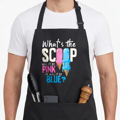 Gender ice cream apron - Stacked text with melting pink and blue ice cream cones replacing letters in scoop — shown on a black cotton canvas apron against a white background