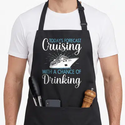 Cruising cruise family aprons - White and blue cruise ship with weather forecast pun text — shown on a black cotton canvas apron against a white background