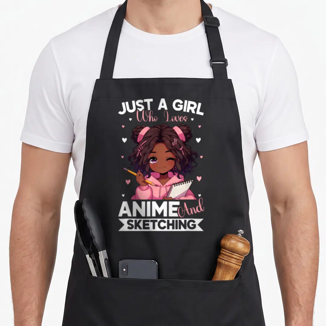Afro anime apron - Cartoon girl holding pencil and sketchbook with text JUST A GIRL Who Loves ANIME And SKETCHING — shown on a black cotton canvas apron against a white background