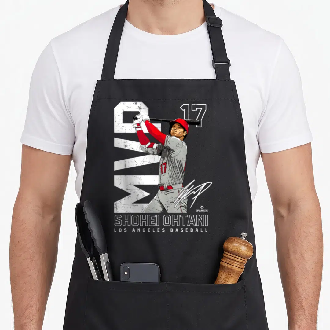 Shohei mvp apron - Cartoon baseball player swinging bat with number 17 and Shohei Ohtani Los Angeles Baseball text — shown on a black cotton canvas apron against a white background