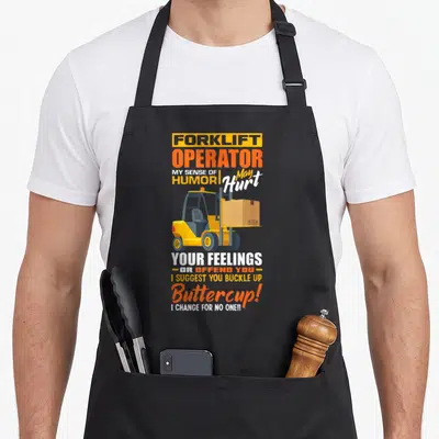 Sense forklift apron - Yellow forklift carrying box surrounded by sarcastic orange and white text on black background — shown on a black cotton canvas apron against a white background