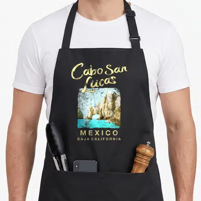 Cabo san lucas mexico apron - El Arco rock arch photo with yellow script text reading Cabo San Lucas and Baja California — shown on a black cotton canvas apron against a white background
