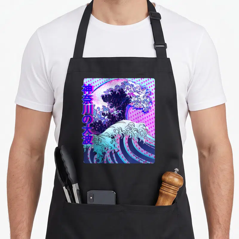 Wave vaporwave apron - Stylized Great Wave of Kanagawa in blue pink purple white with vertical Japanese text — shown on a black cotton canvas apron against a white background