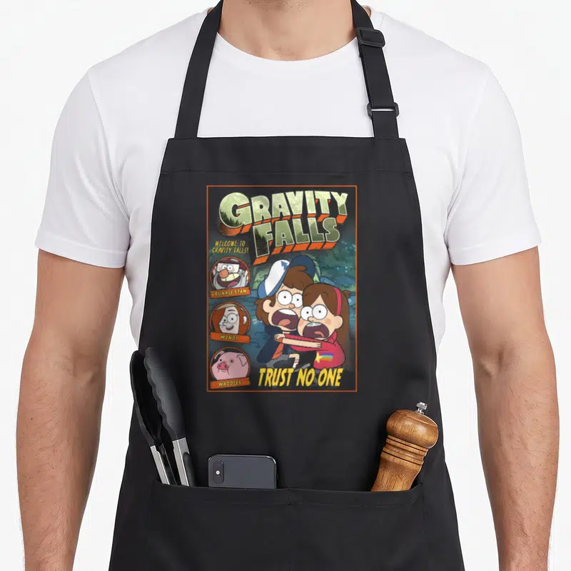 Gravity fall apron - Cartoon Dipper Mabel portraits with Trust No One text and three side icons — shown on a black cotton canvas apron against a white background