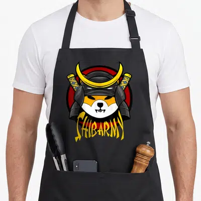 Shib coin apron - Cartoon dog head in samurai helmet with crossed swords and SHIBARMY text on red circle — shown on a black cotton canvas apron against a white background