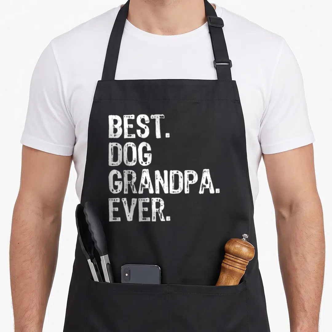 Dog grandpa apron - White stacked text reading best dog grandpa ever on grey background — shown on a black cotton canvas apron against a white background