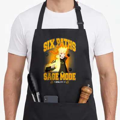 Six sage apron - Naruto Six Paths Sage Mode with four black spheres and orange text on black — shown on a black cotton canvas apron against a white background