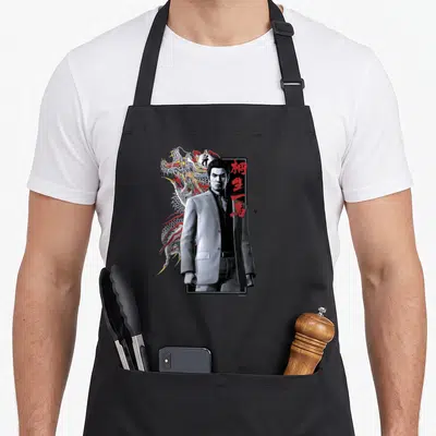 Sega dragon apron - Man in grey suit with dragon and red kanji text — shown on a black cotton canvas apron against a white background