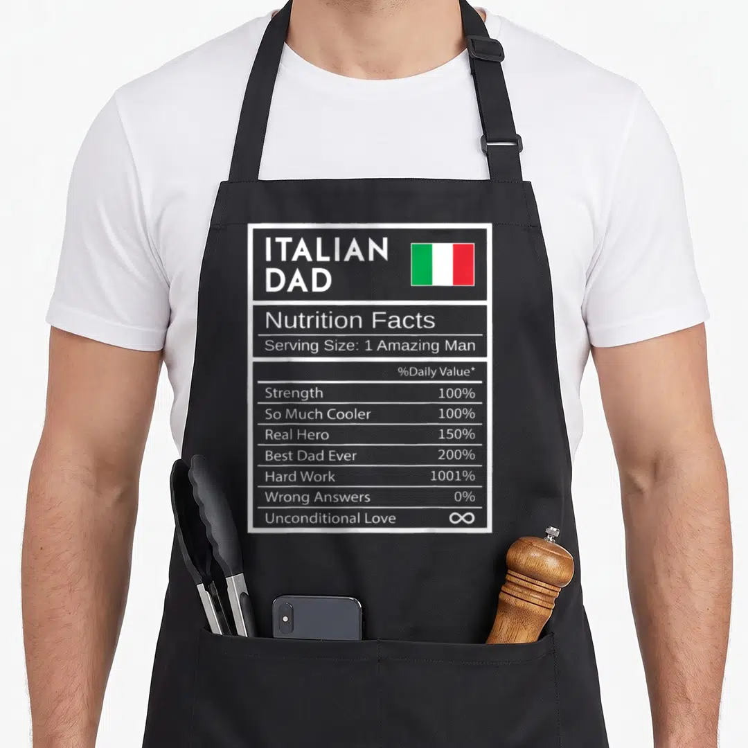 Fact italian aprons - Italian Dad nutrition label with flag, 1001% hard work, infinite love text — shown on a black cotton canvas apron against a white background
