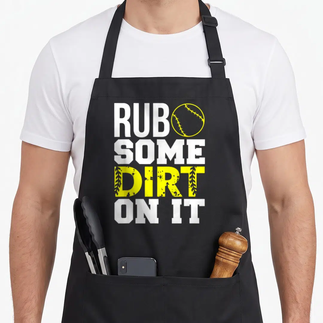 Rub softball mom apron - Rub Some Dirt On It text with yellow softball and stitched DIRT letters on black — shown on a black cotton canvas apron against a white background