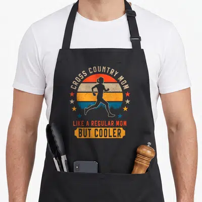 Trail country apron - Retro striped sun with running woman silhouette, stars, and text celebrating cross country mom — shown on a black cotton canvas apron against a white background