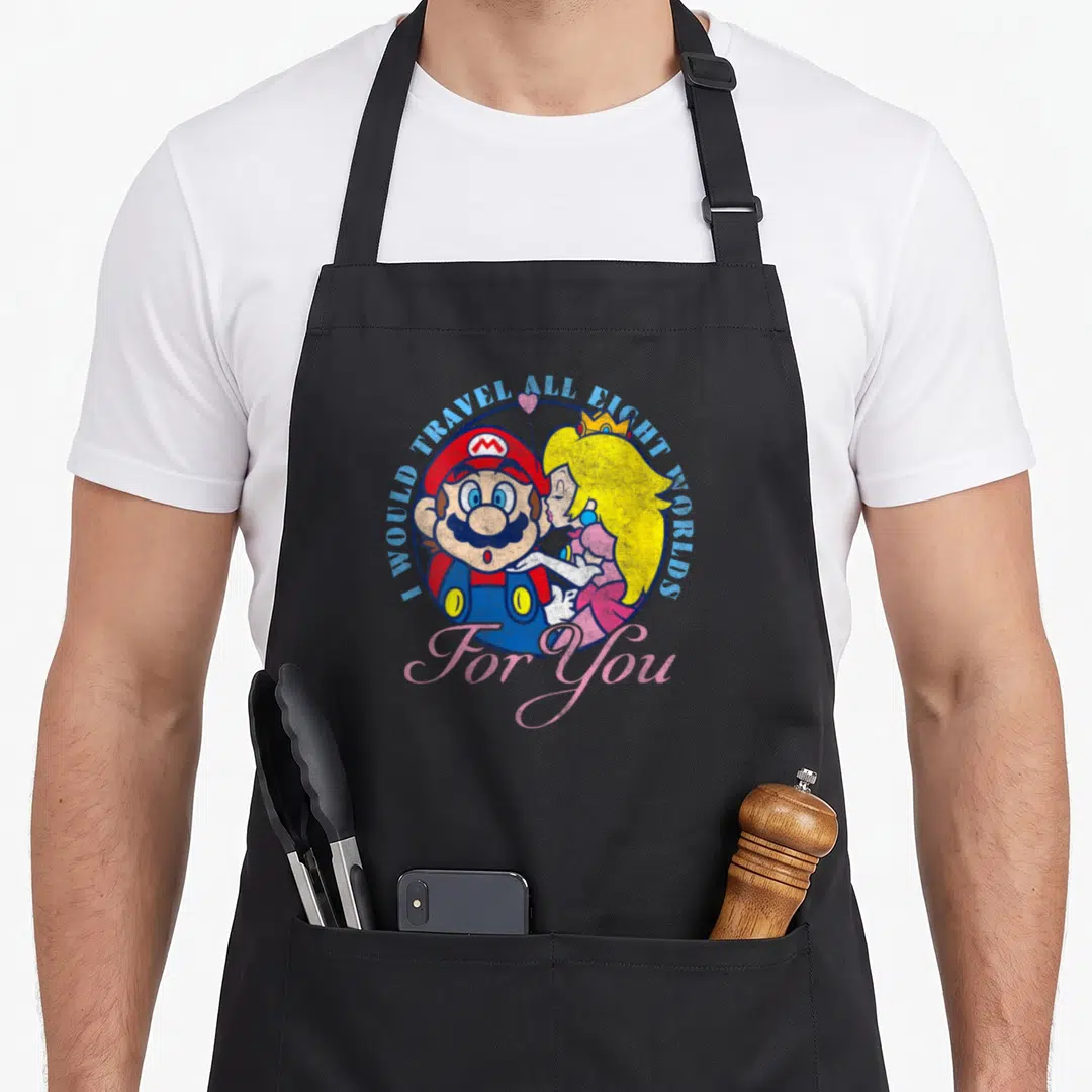 Eight peach apron - Mario and Peach cartoon with arched blue text and pink For You script — shown on a black cotton canvas apron against a white background