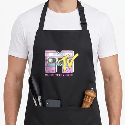 Mtv tape apron - Pink and yellow cartoon cassette tape with mix tape and music television text — shown on a black cotton canvas apron against a white background