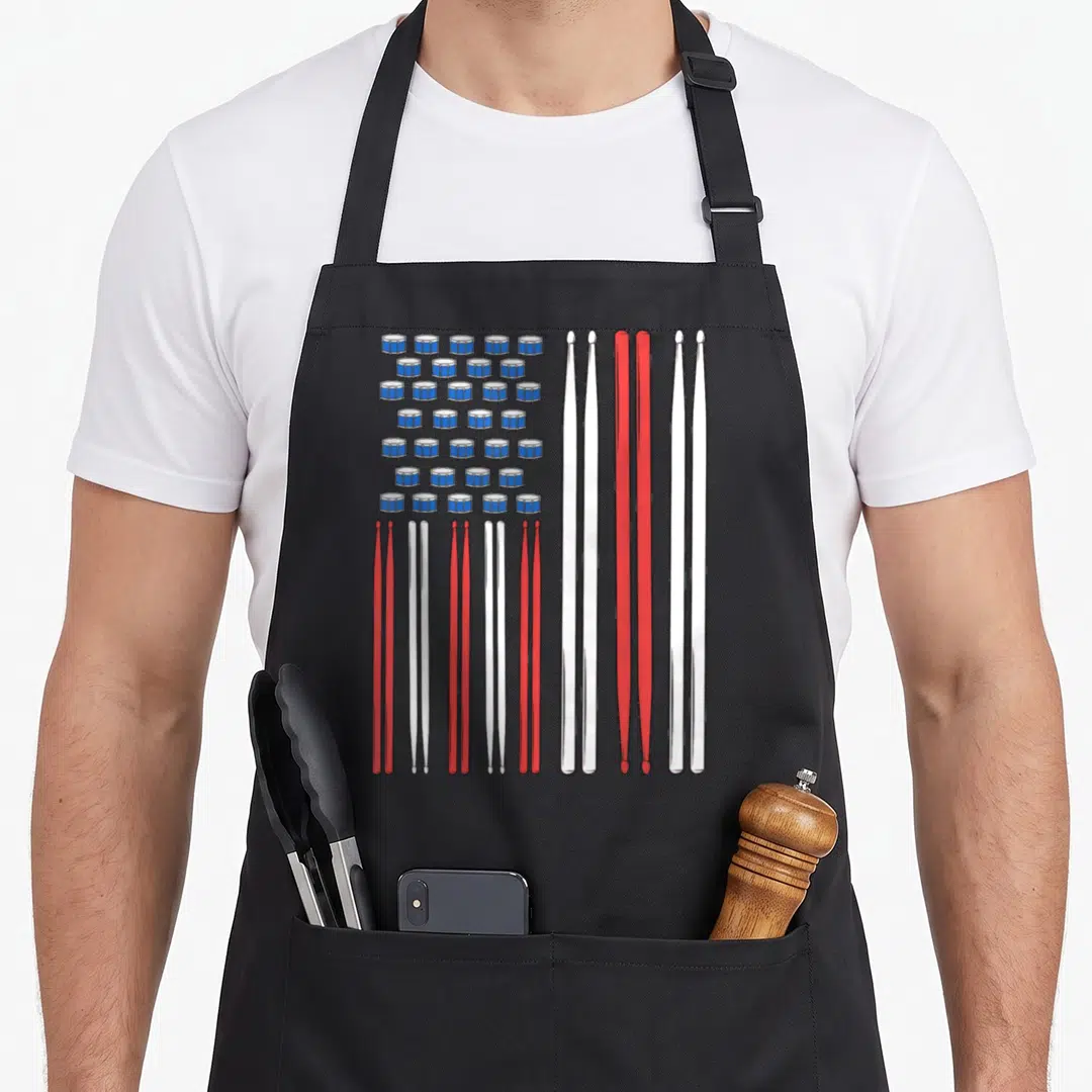 Drum i love my pigeon apron - Blue drums and red white drumsticks arranged in a US flag pattern — shown on a black cotton canvas apron against a white background