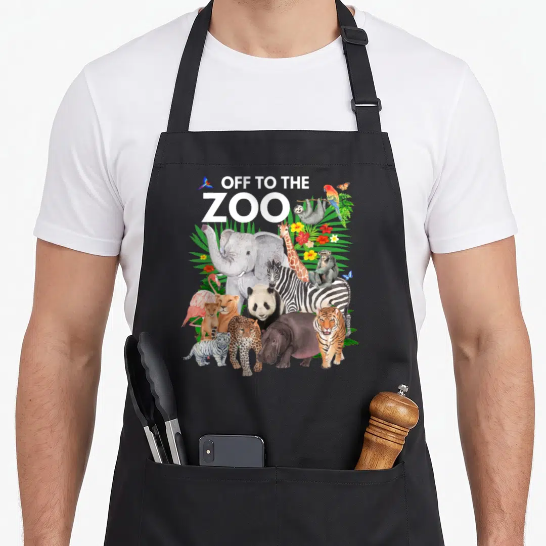 Zoo safari animal apron - Watercolor collage of elephants, tigers, zebras, and giraffes below text with tropical leaves — shown on a black cotton canvas apron against a white background