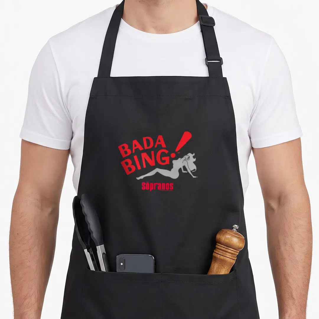 Bada sopranos apron - Red BADA BING text, grey woman silhouette, and THE Sopranos logo — shown on a black cotton canvas apron against a white background
