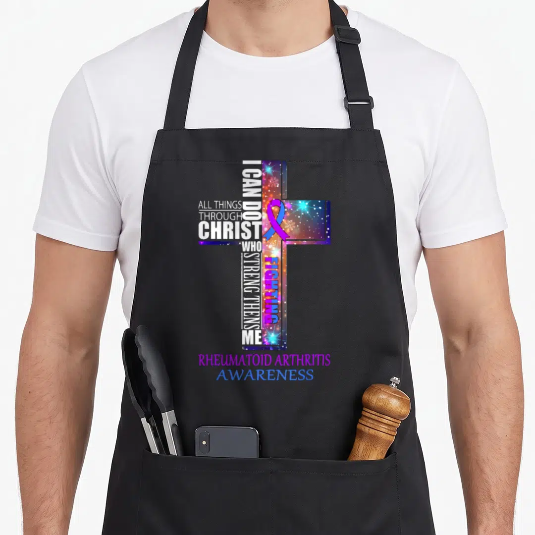 Rheumatoid christmas apron - Cross typography with I can do all things text and purple blue awareness ribbon — shown on a black cotton canvas apron against a white background