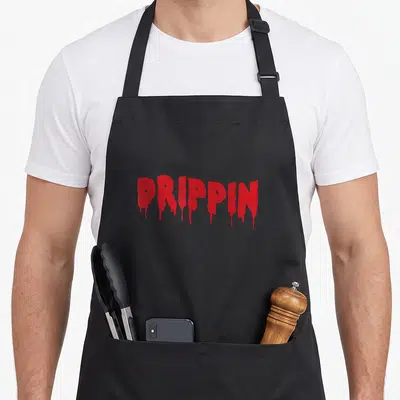Drippin hip apron - Red dripping DRIPPIN text on black background — shown on a black cotton canvas apron against a white background