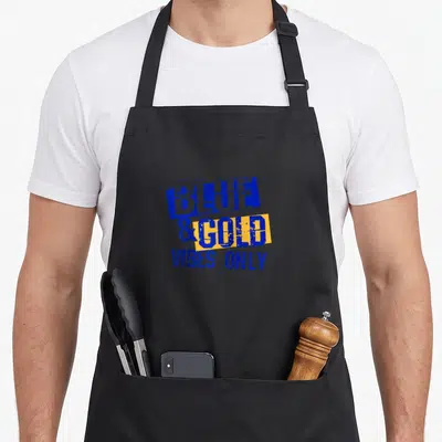 Game school football apron - Stacked blue and yellow rectangles with distressed text reading blue and gold vibes only — shown on a black cotton canvas apron against a white background