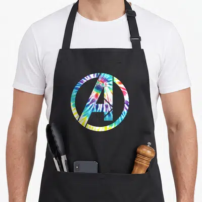 Icon tie apron - Tie-dye Avengers A logo in blue red yellow white purple swirl pattern — shown on a black cotton canvas apron against a white background