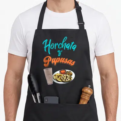 Horchata el cook apron - Cartoon glass of horchata and plate of pupusas with stacked cyan and orange text — shown on a black cotton canvas apron against a white background