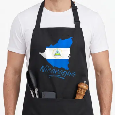 Blue nicaragua apron - Map of Nicaragua filled with blue and white flag stripes and script text below — shown on a black cotton canvas apron against a white background