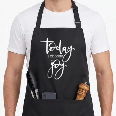 Choose join today apron - White stacked typography reading today i choose joy on grey background — shown on a black cotton canvas apron against a white background
