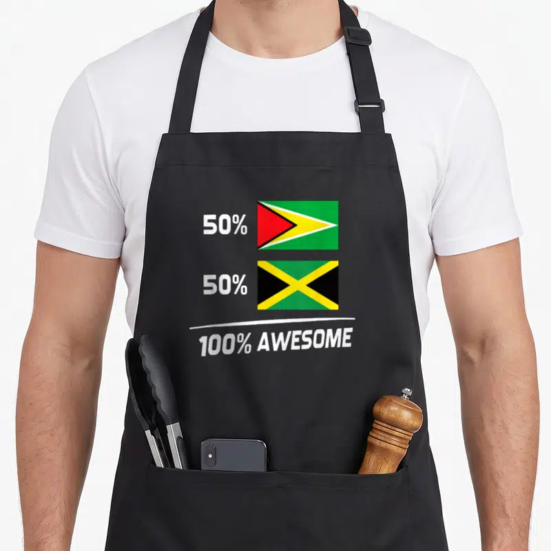 Jamaican guyana apron - Stacked Guyana and Jamaica flags with 50 percent 100 percent awesome text — shown on a black cotton canvas apron against a white background