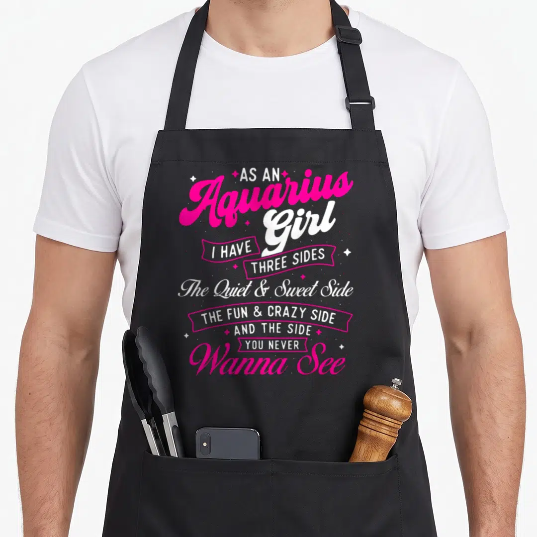 Aquarius a's aprons - Pink and white text reading As an Aquarius Girl I Have Three Sides surrounded by stars — shown on a black cotton canvas apron against a white background